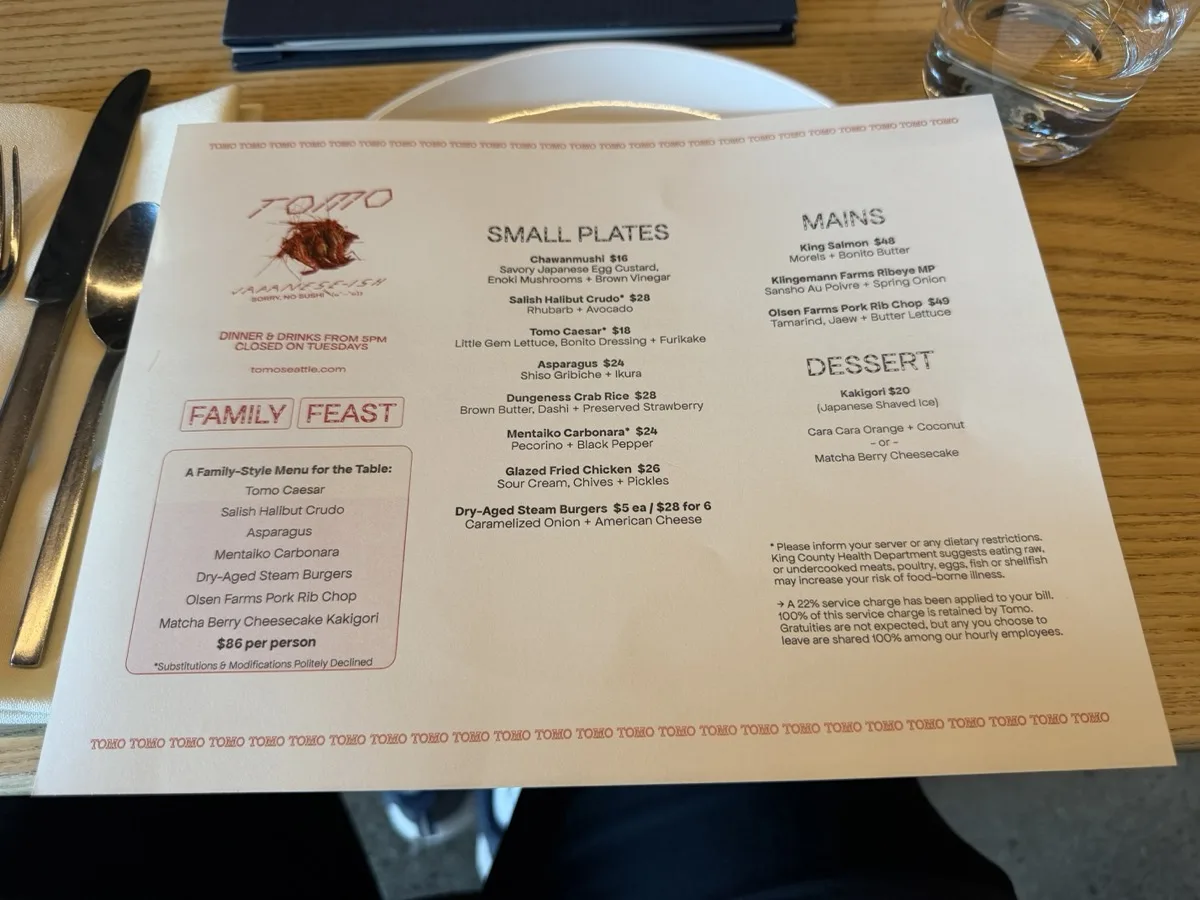 The Tomo dinner menu showing the Family Feast at 86 dollars per person and the 22% service charge